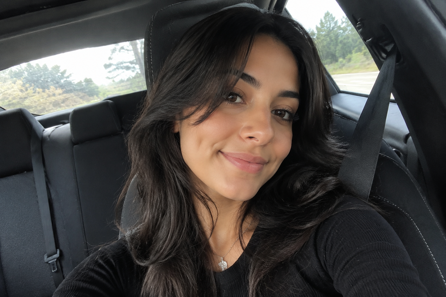 Input selfie in a car with mixed daylight and angled framing